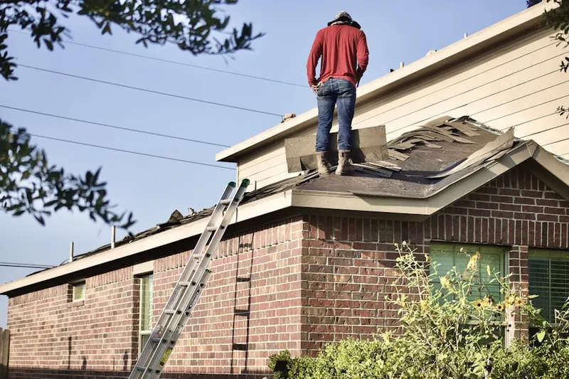 Professional roofer working on a residential roof in East Riverdale